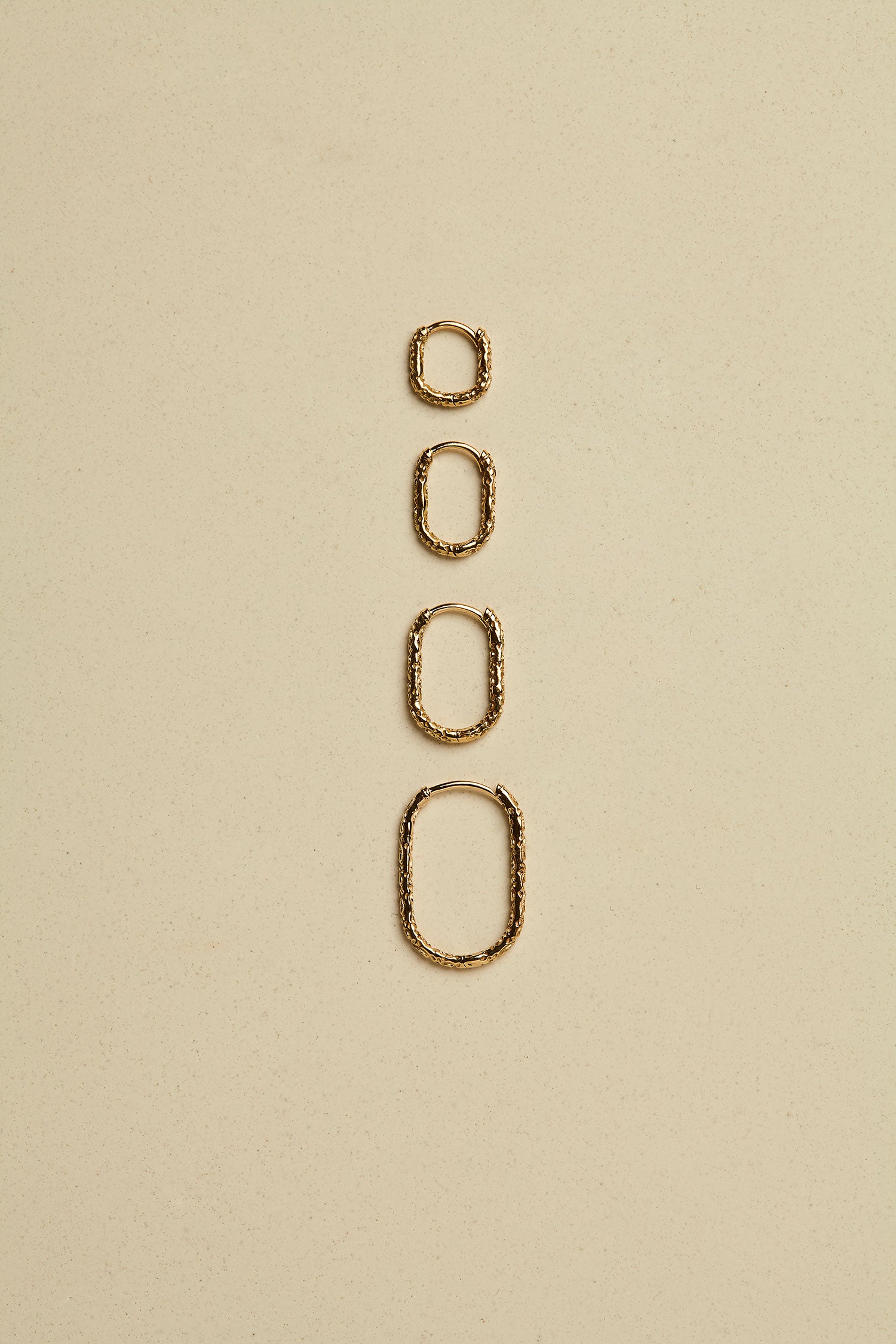Engraved Oval Clicker Hoop still life image by metier by tomfoolery
