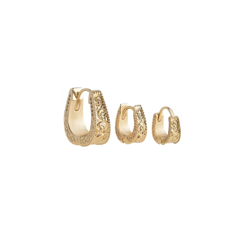 A set of three gold huggie earrings with textured details, displayed in ascending size order.