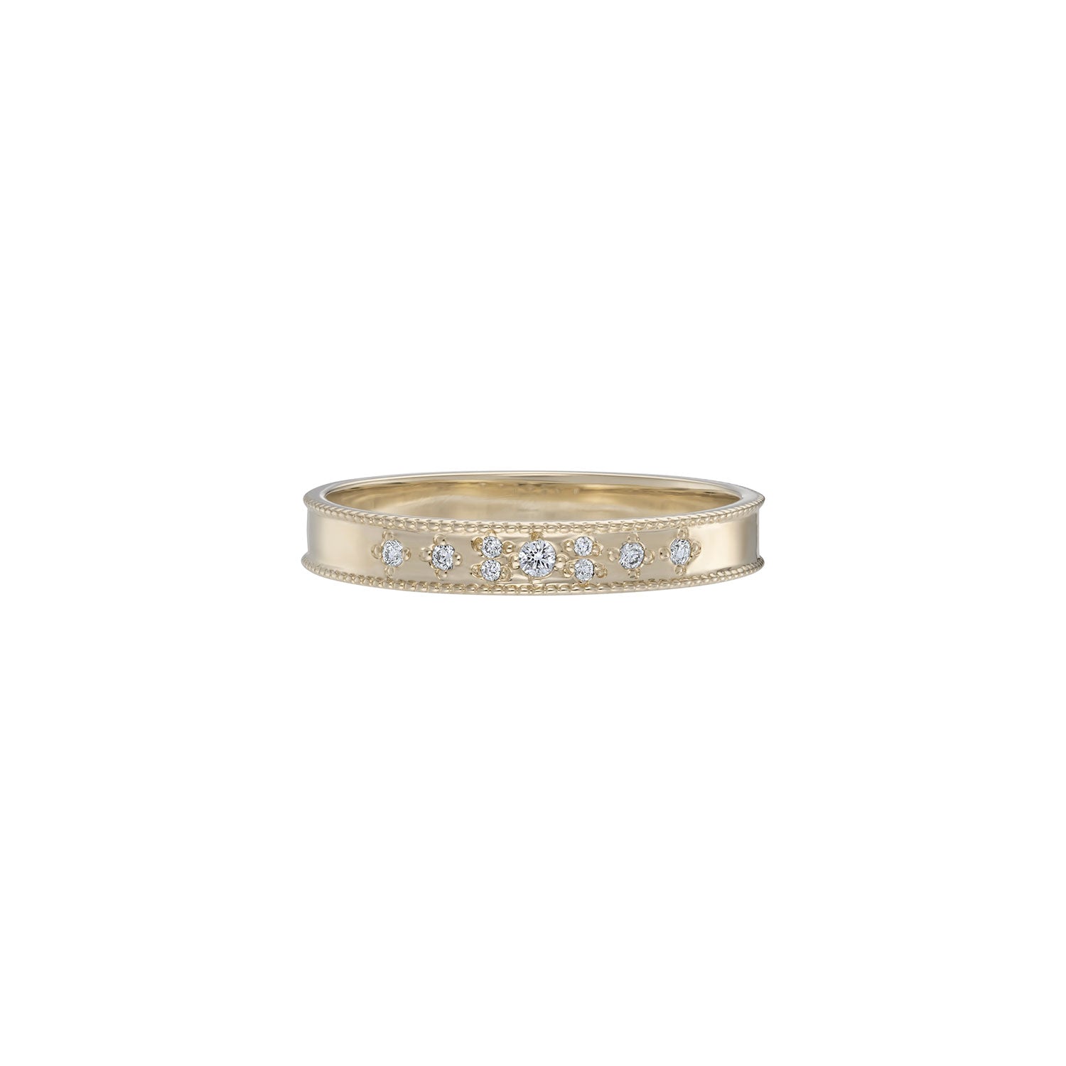 A narrow yellow gold band featuring white diamonds set in a scattered pattern with milgrain detailing on the edges.