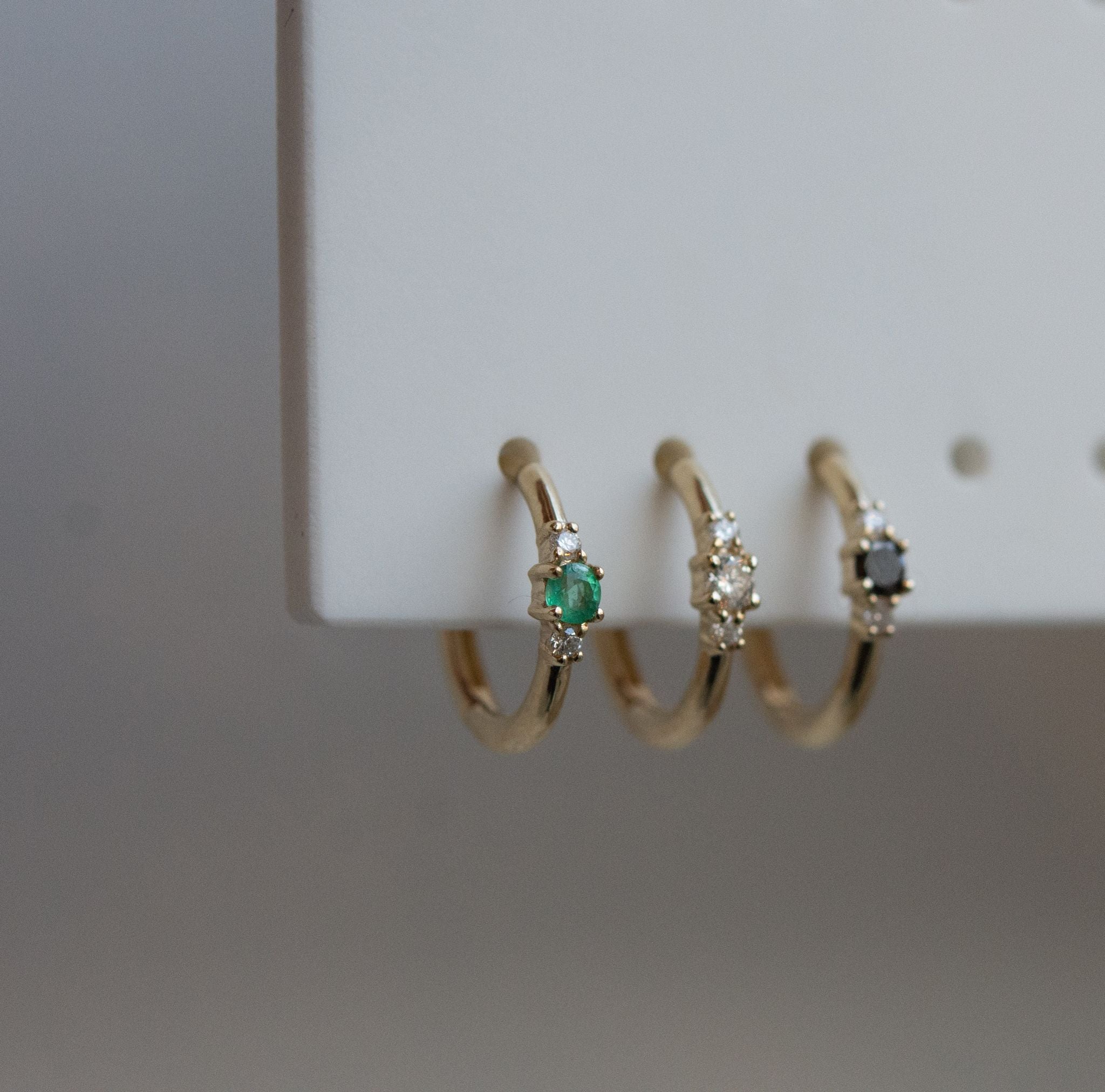 Métier by tomfoolery Petite Triple Gemstone Clicker Hoop Earrings. 9ct yellow gold. white diamond, black diamond. emerald.