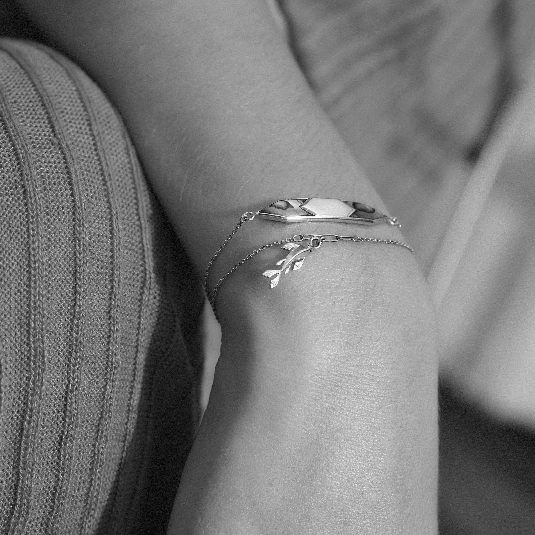 gold braceet with Koi design on a person's wrist